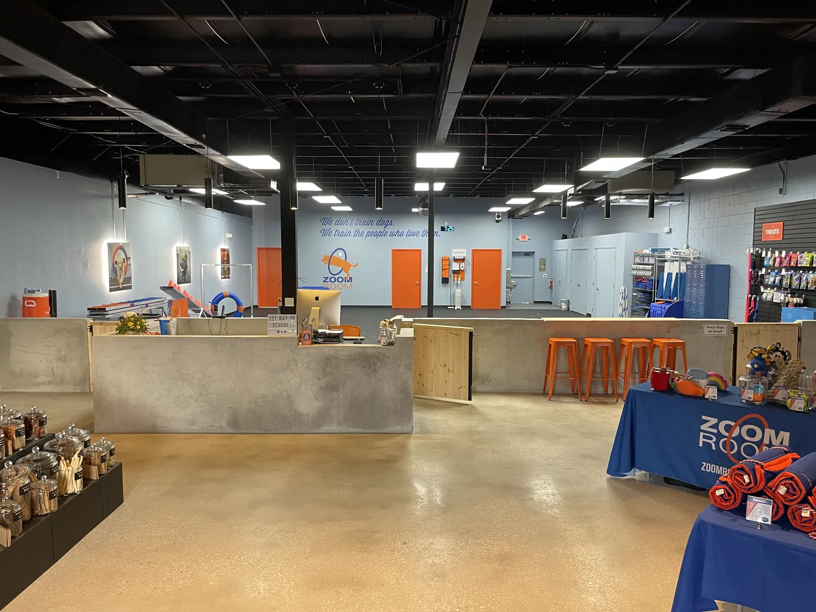Finished Zoom Room Longwood interior with reception counter, retail displays and polished concrete floor